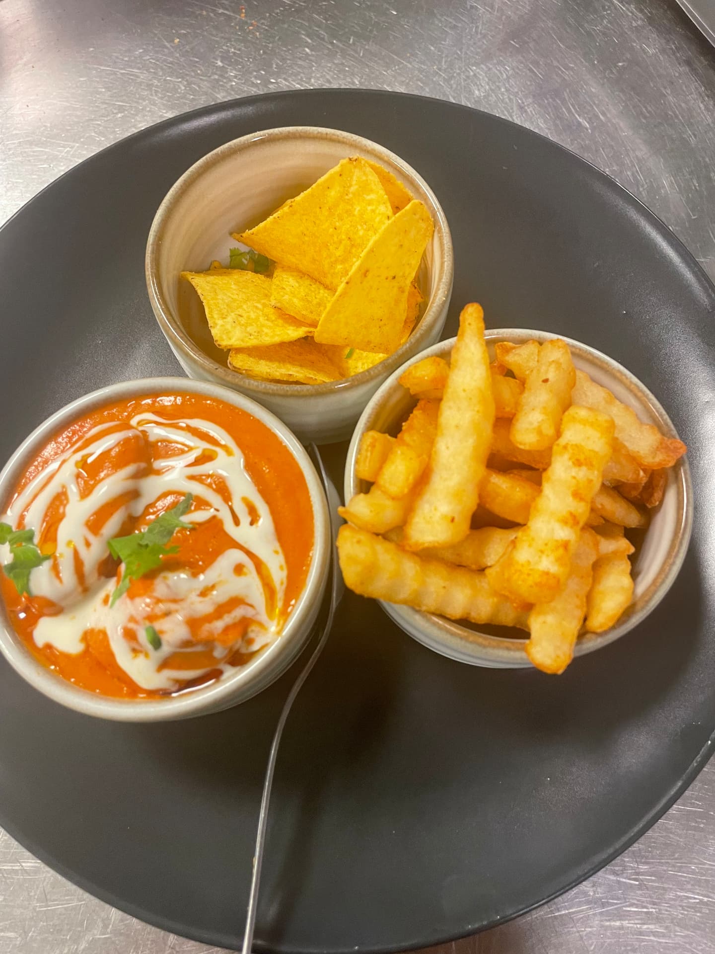 Kids Butter Chicken meal at Namaste Express — mild creamy chicken curry with fries and nachos served family style